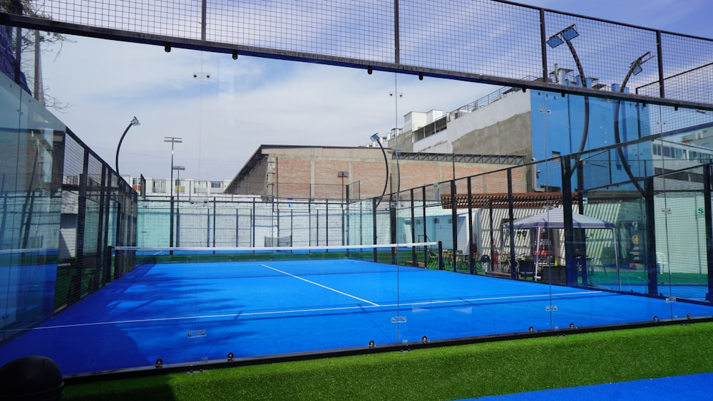 a tennis court with a blue tennis court cover