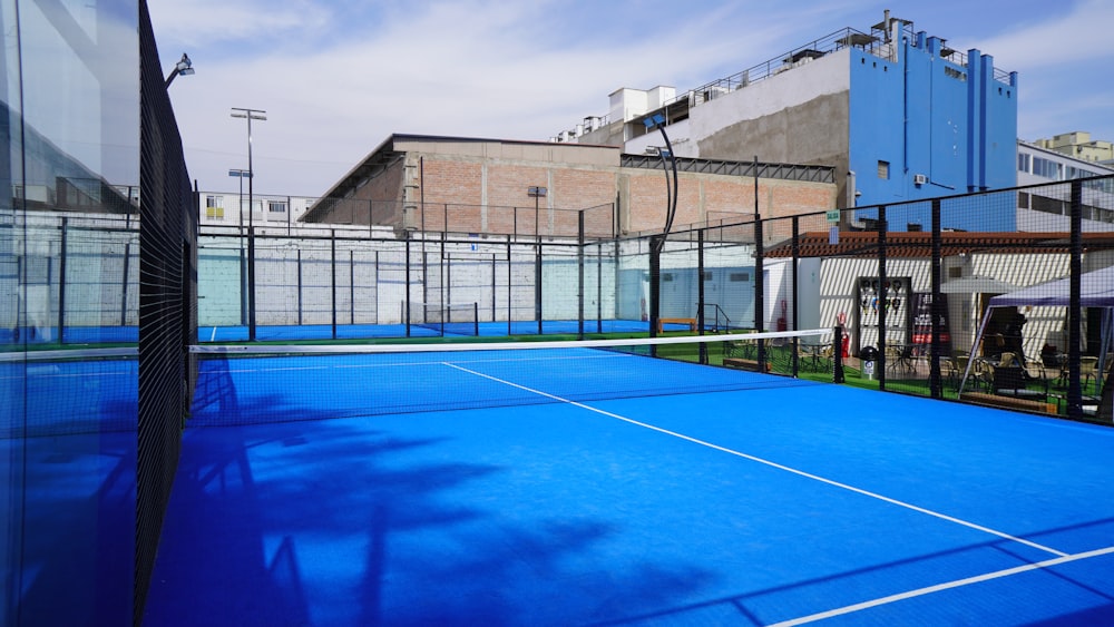 a tennis court with a blue tarp on it