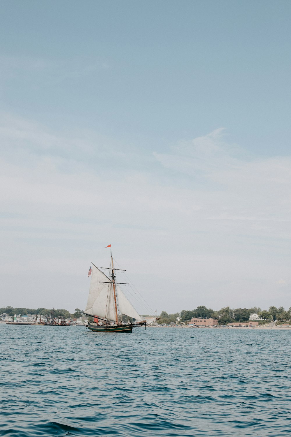 a sailboat sailing on a body of water