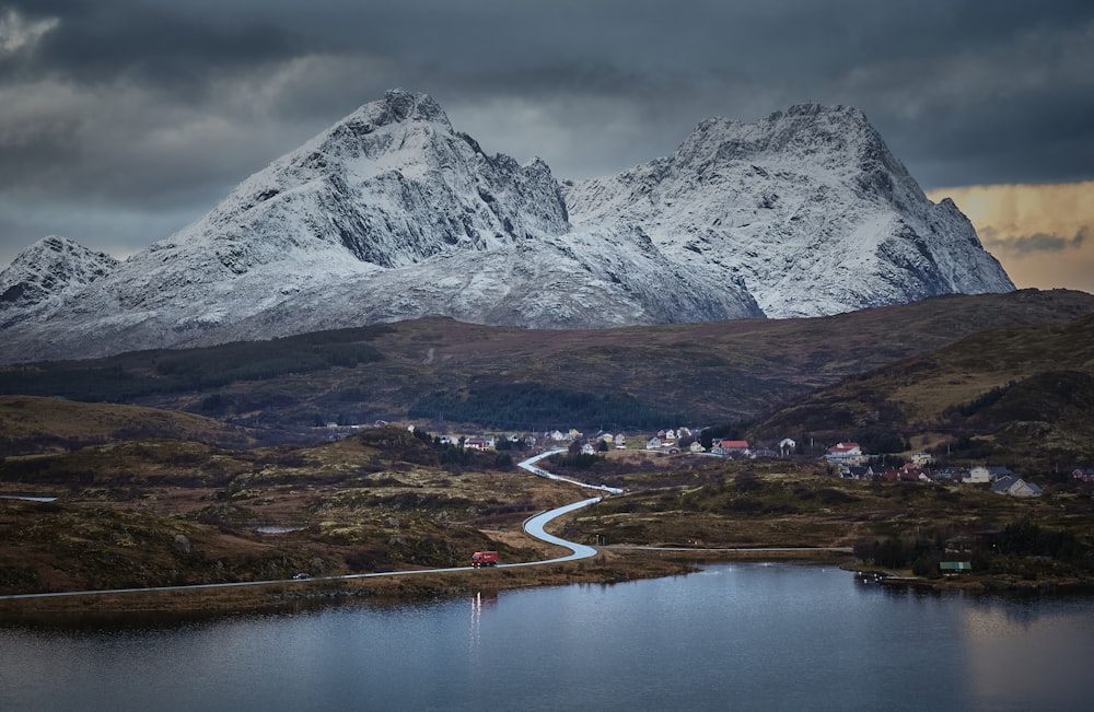 a view of a mountain range with a lake in the foreground