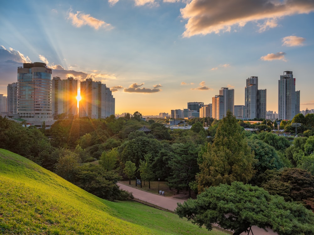 the sun is setting over the city skyline