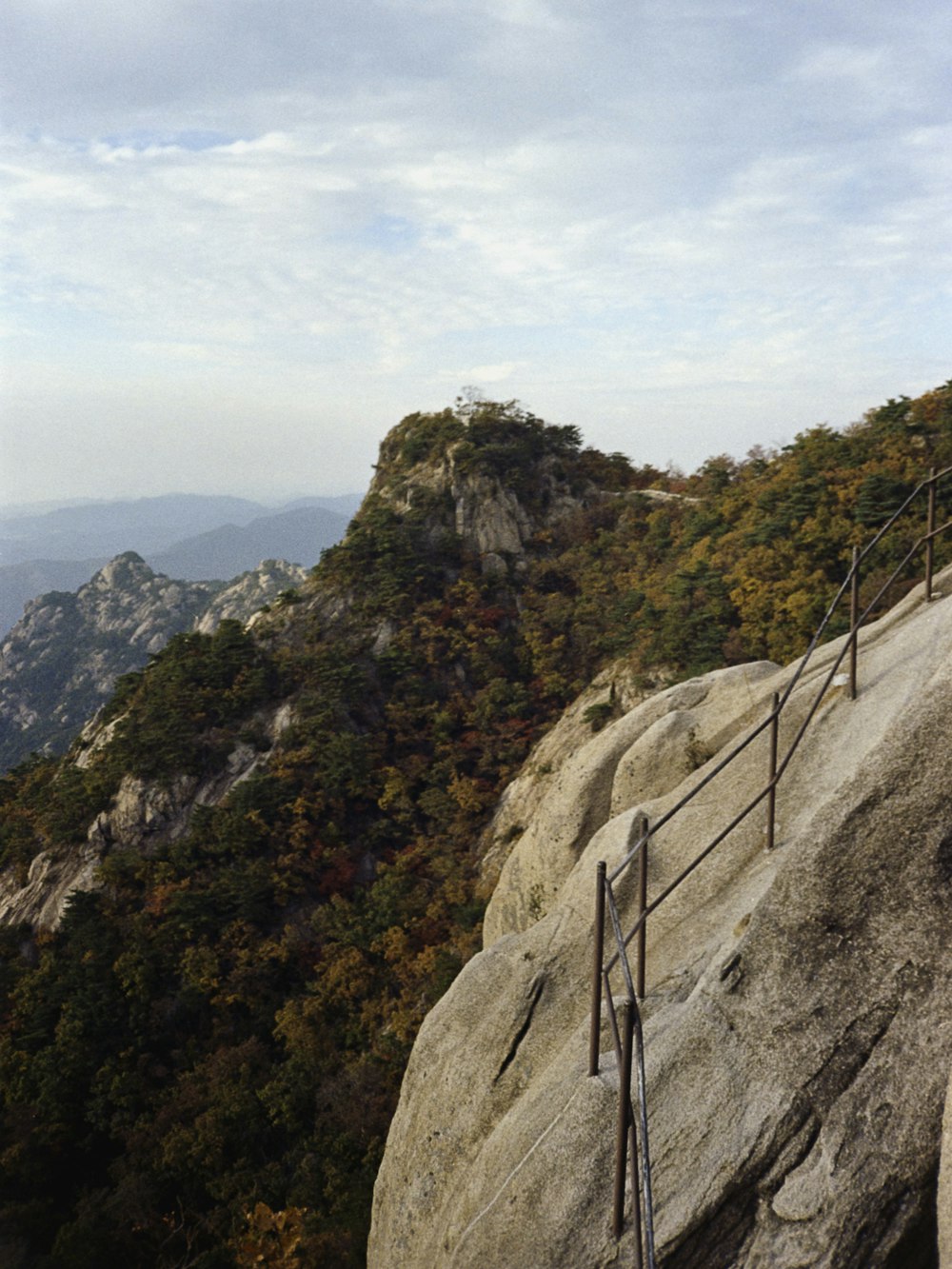 a man riding a skateboard down a metal hand rail