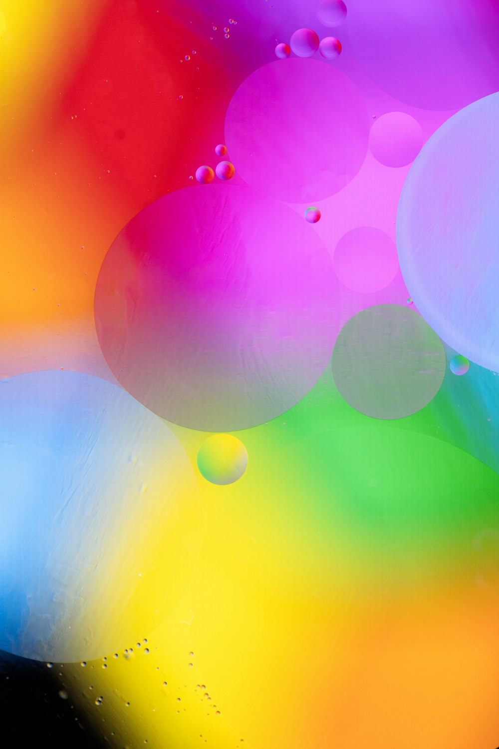 a close up of a multicolored background with drops of water