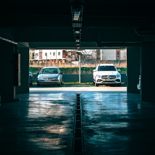 two cars parked in a parking garage next to each other