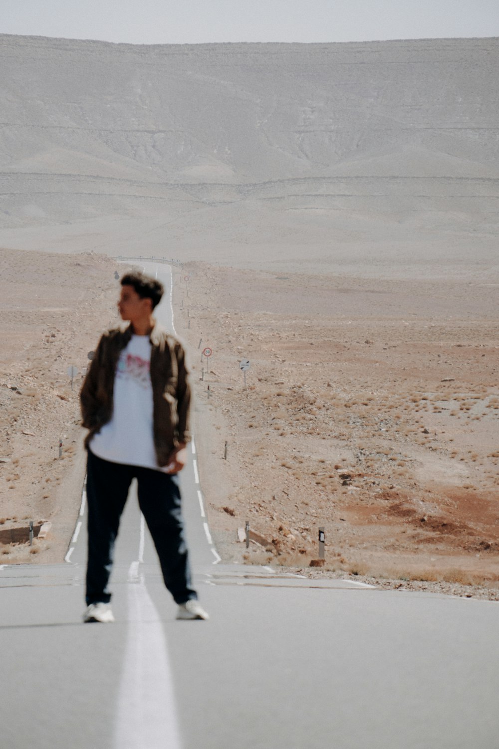 a man standing in the middle of a road