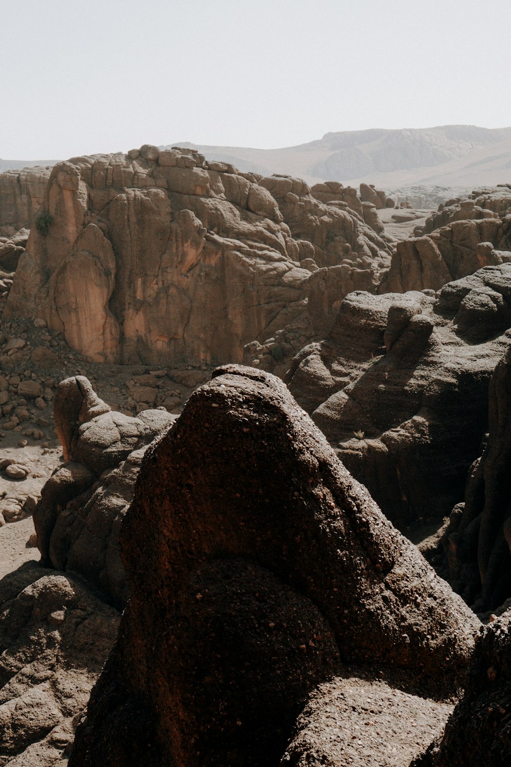 a view of a rocky landscape with a mountain in the background