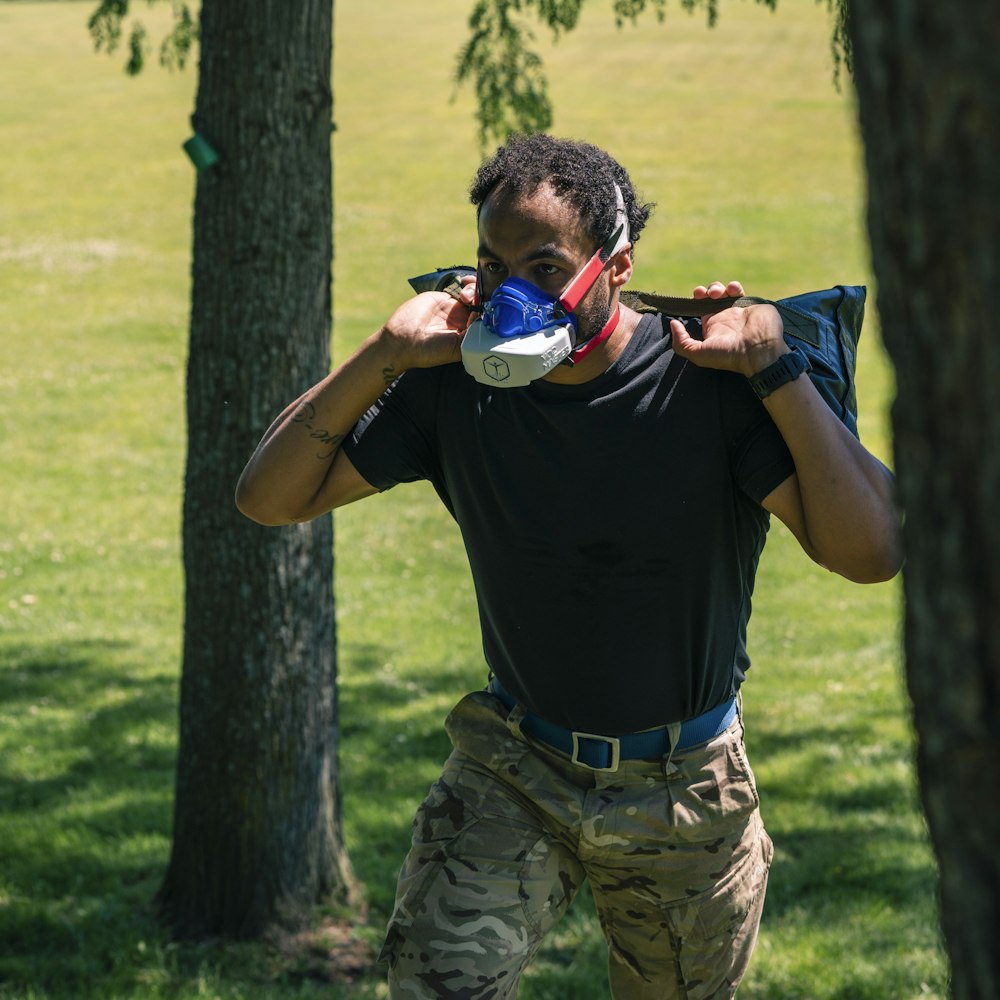 a man holding a frisbee in a park