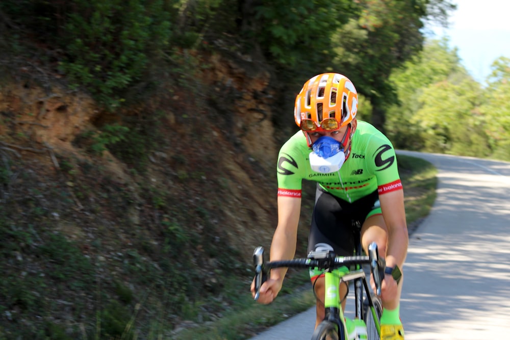 a man riding a bike down a curvy road