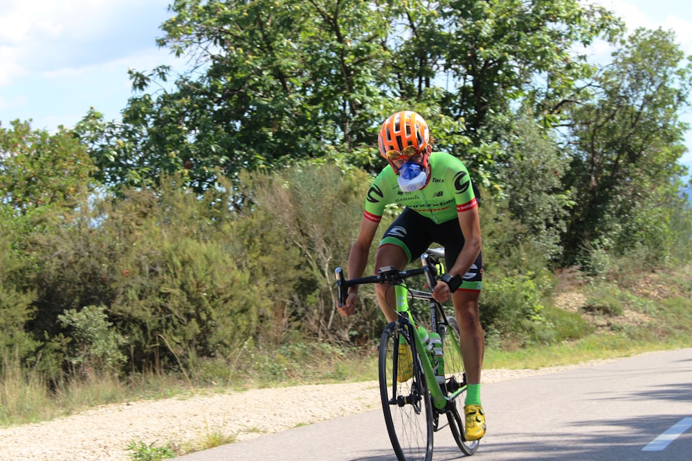 a man riding a bike down a curvy road