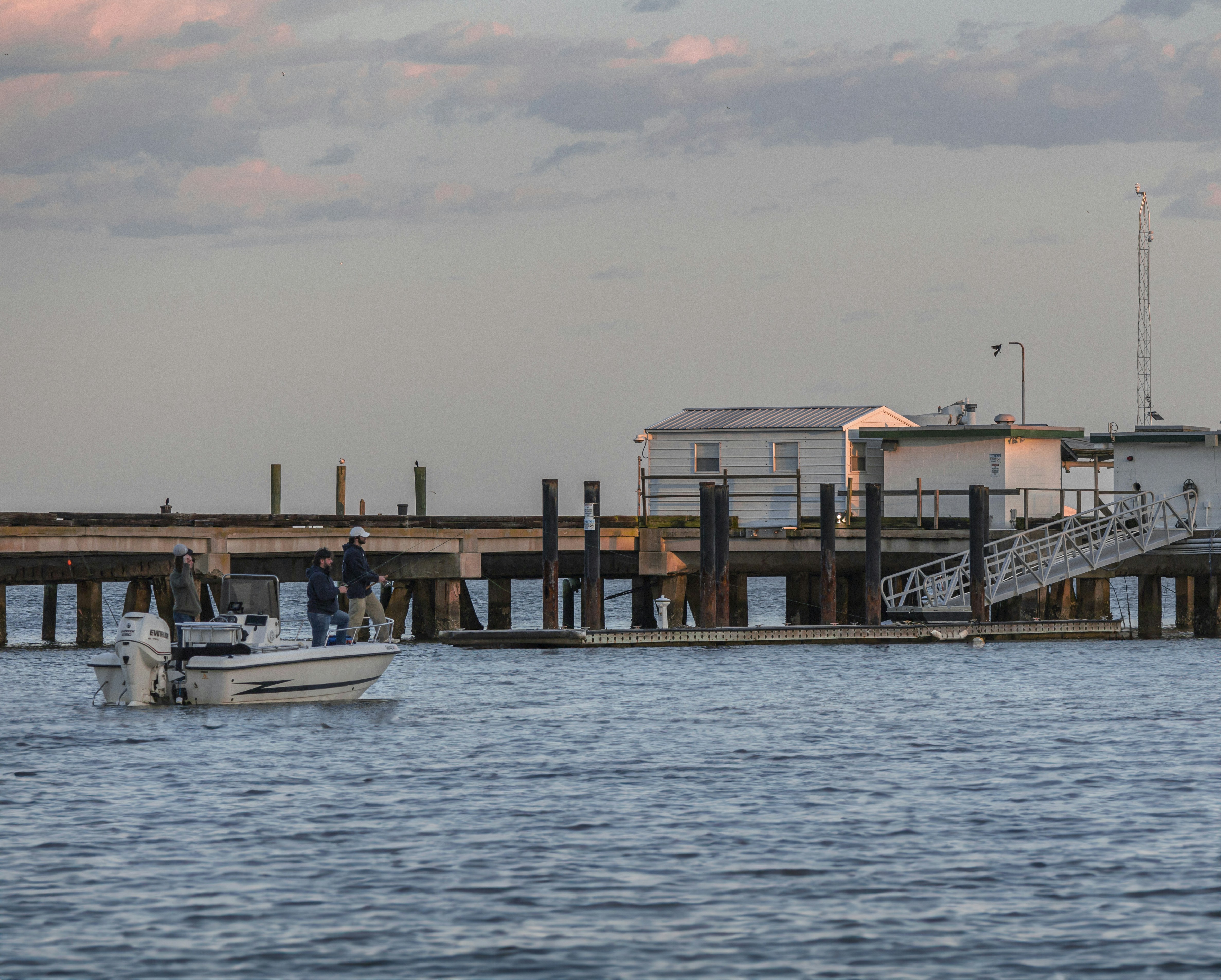 a boat is in the water near a pier