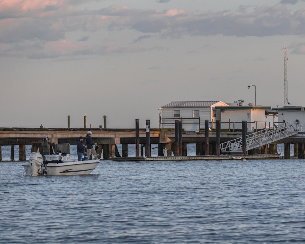 a boat is in the water near a pier