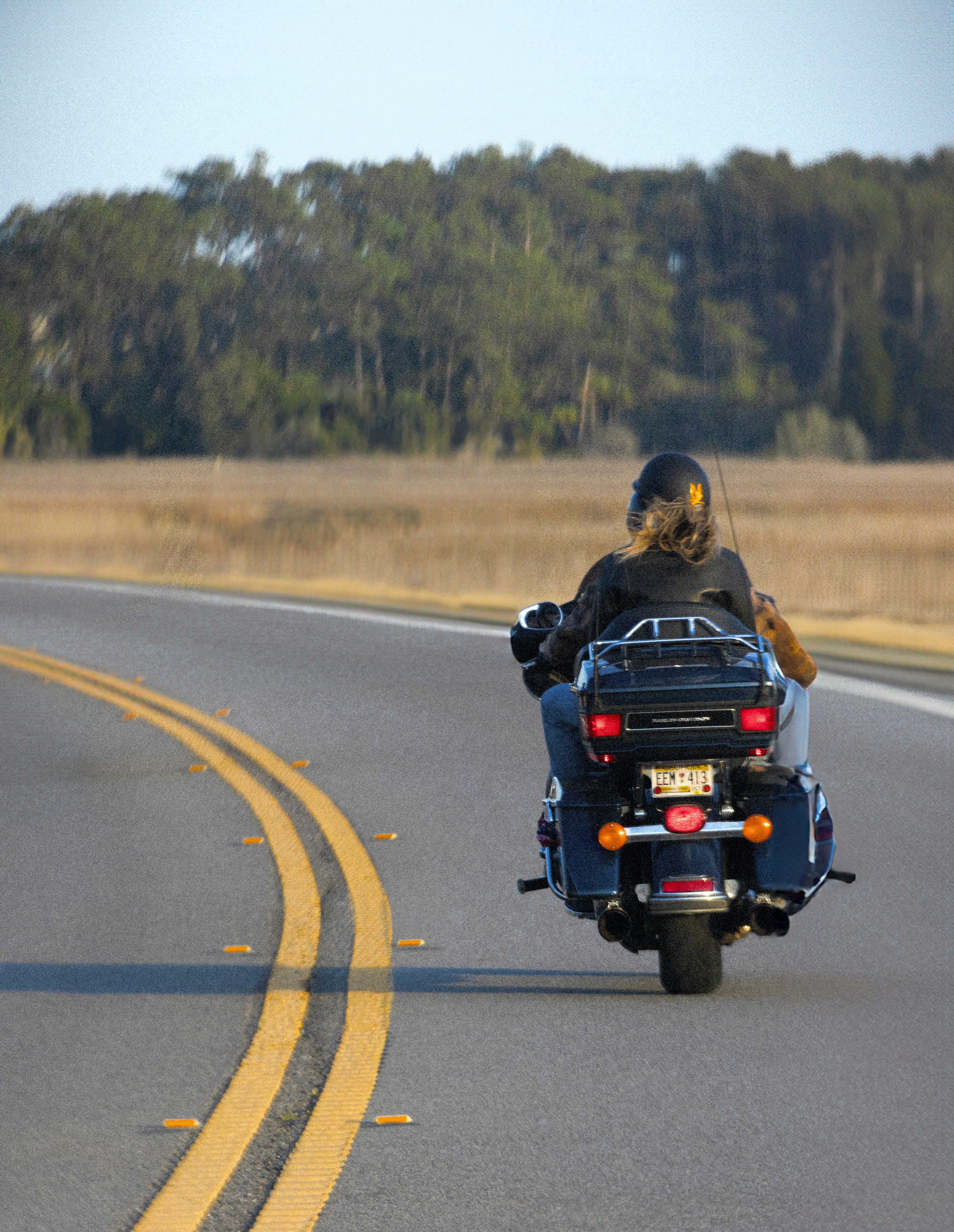 a man riding a motorcycle down a curvy road