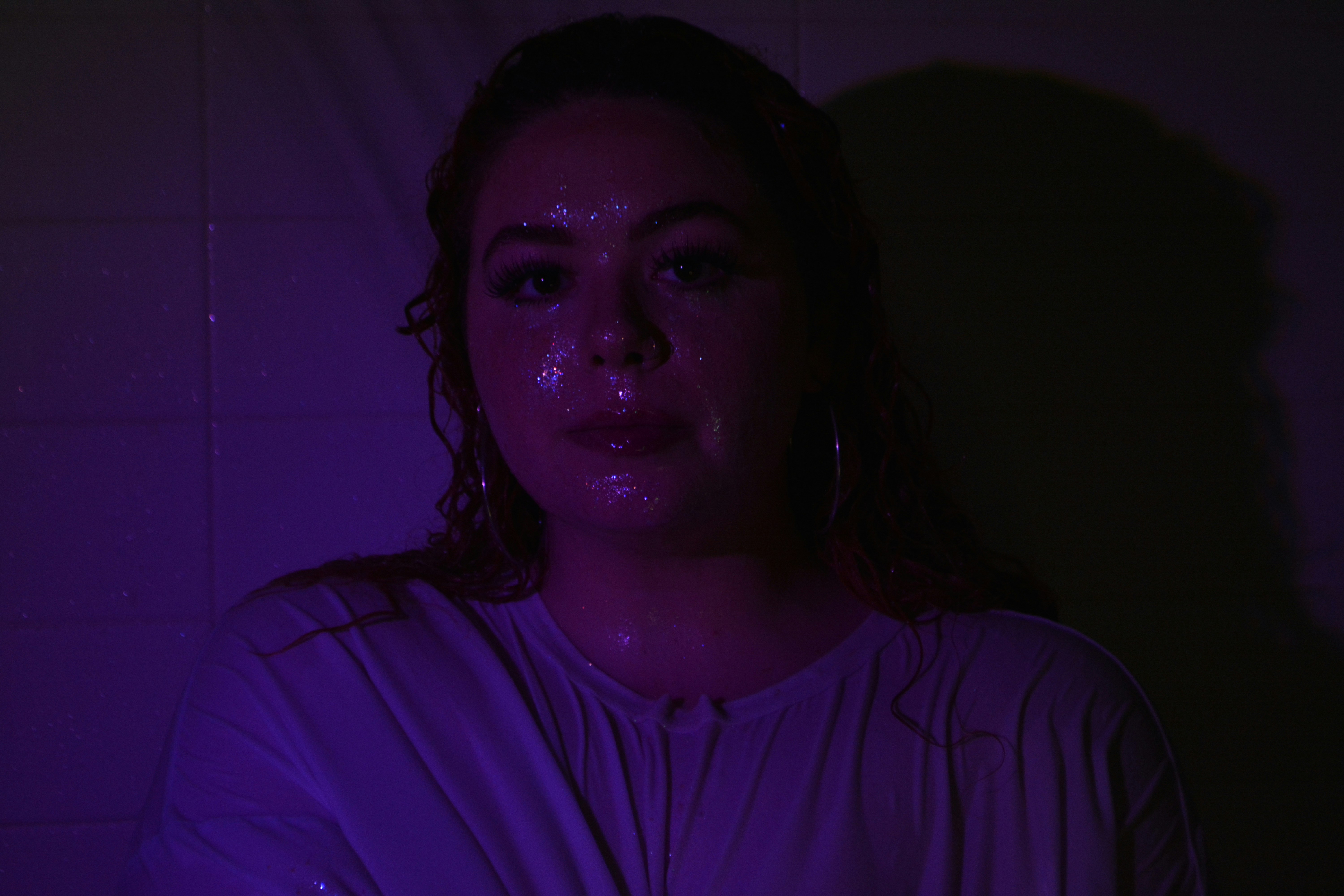 A woman in a dark room with a candle in her hand