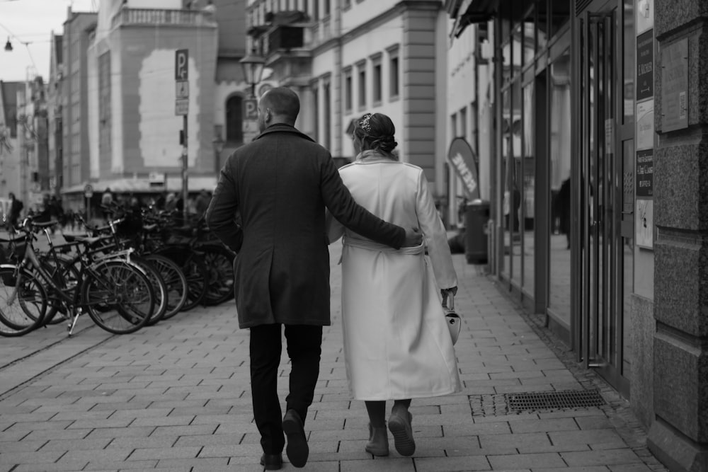 a man and a woman walking down a street