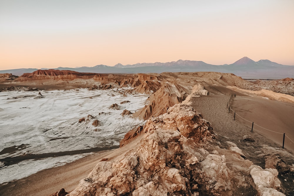 a view of a desert with mountains in the background