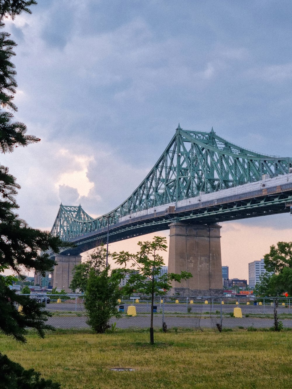 a train going over a bridge on a cloudy day