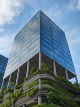 a very tall building with a bunch of plants growing on it