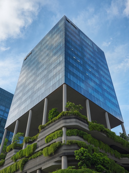 a very tall building with a bunch of plants growing on it