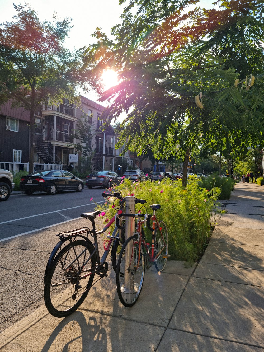 a couple of bikes parked next to each other on a sidewalk