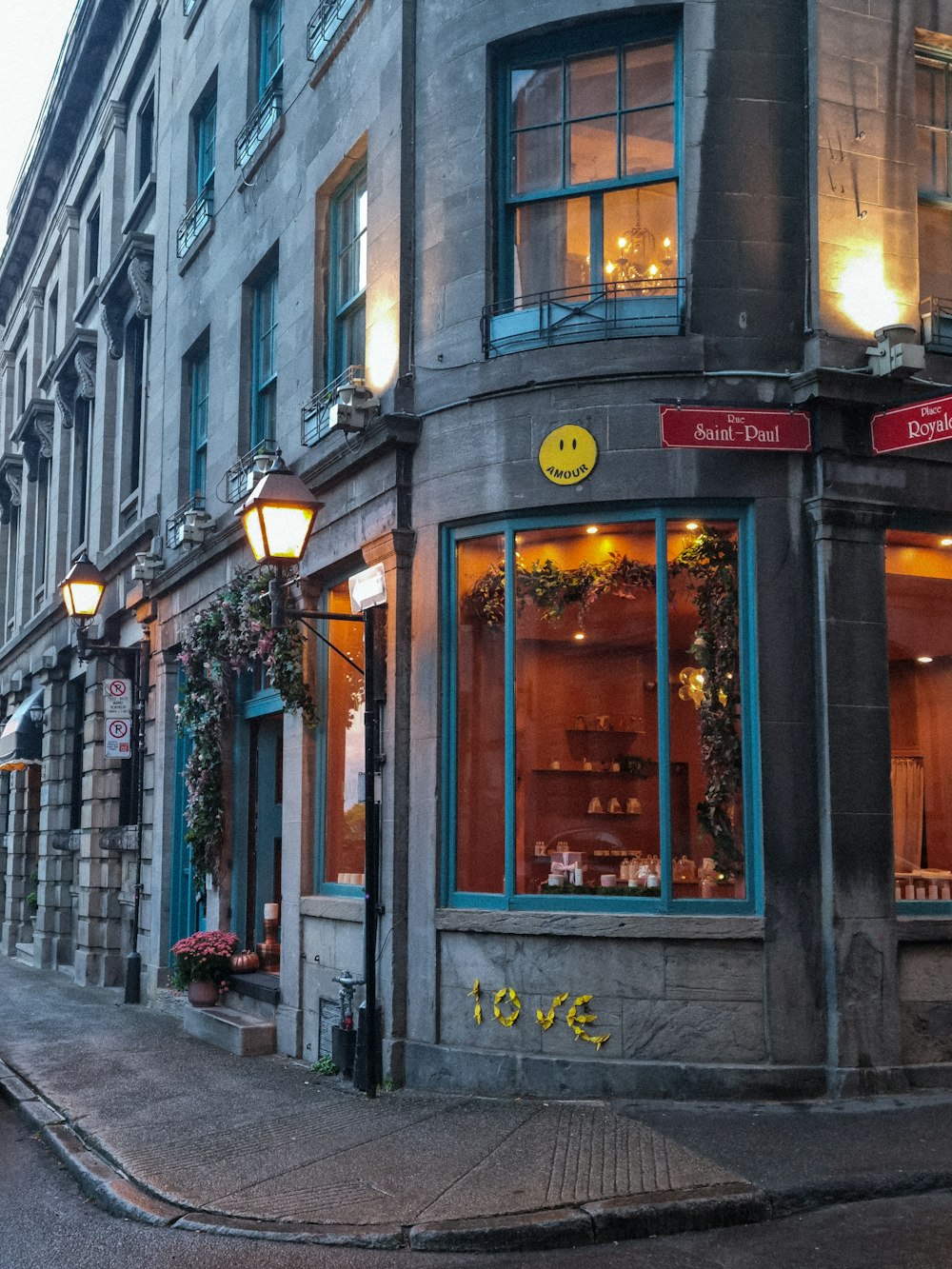 a street corner with a building with a smiley face on it