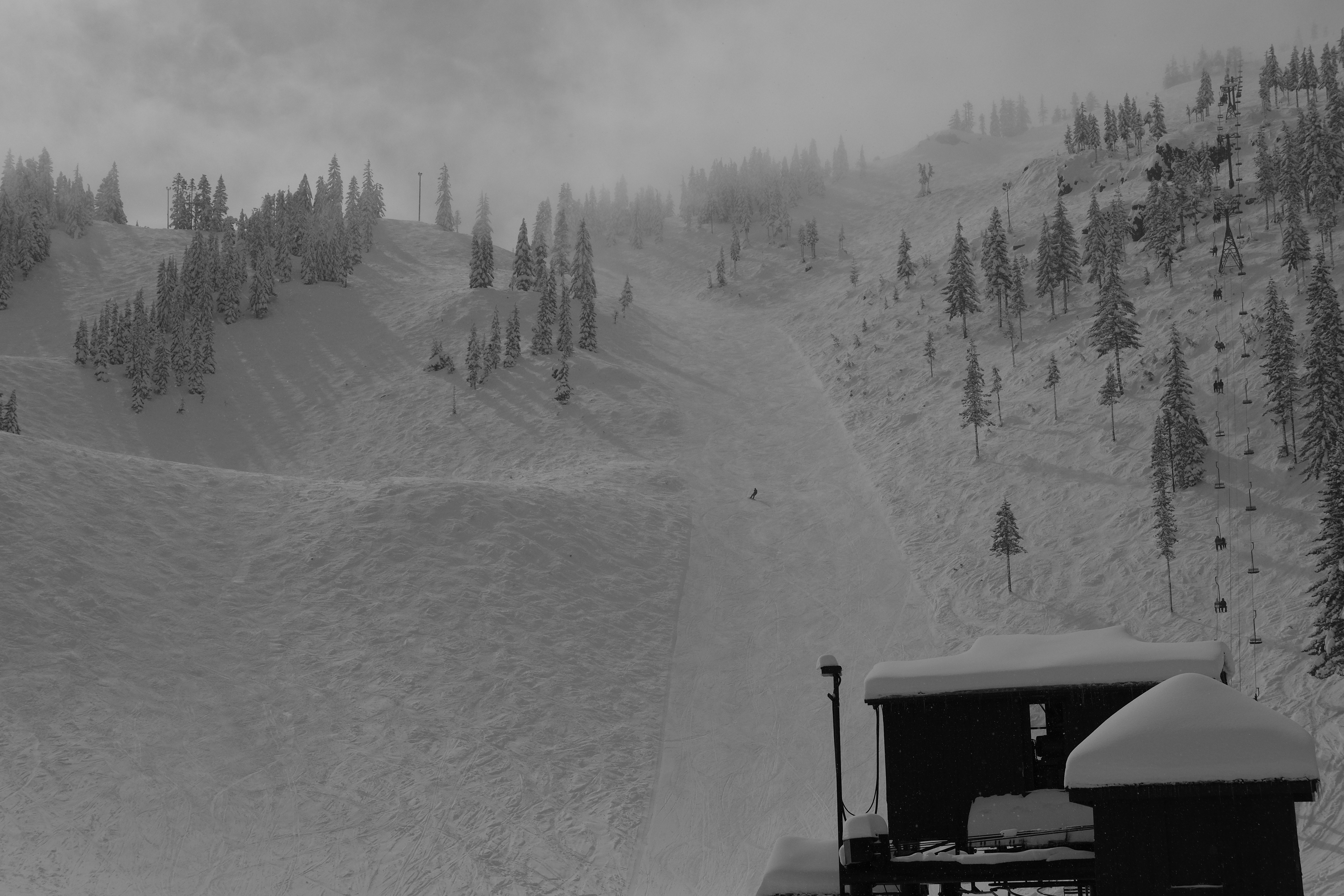 A snowcat working on a wintry mountain