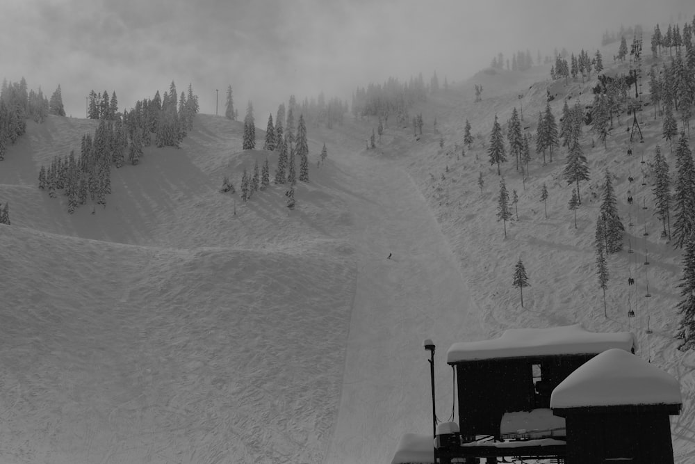 a snow covered mountain with a snow plow in the foreground