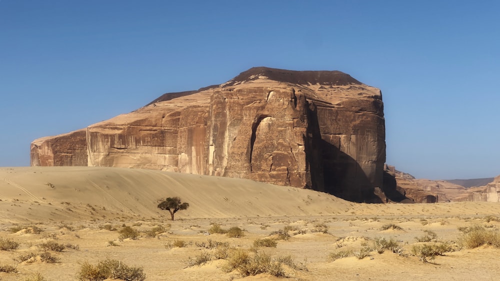 a large rock formation in the middle of a desert