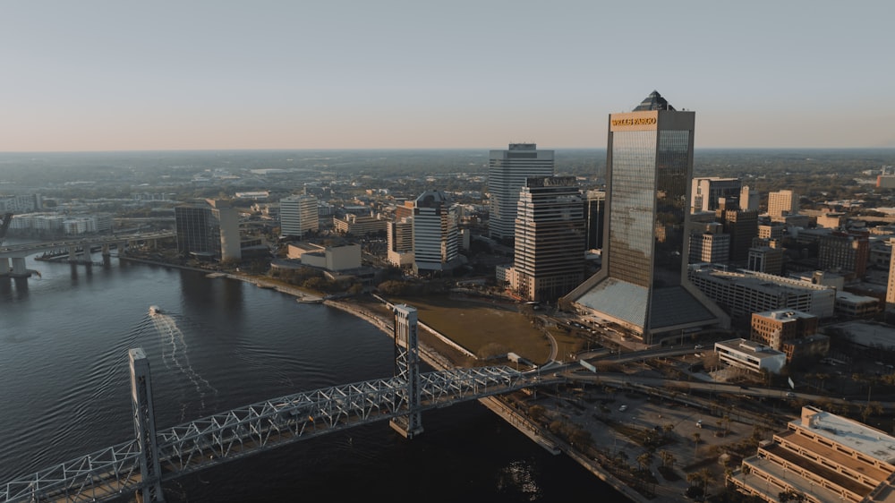 an aerial view of a city with a bridge in the foreground