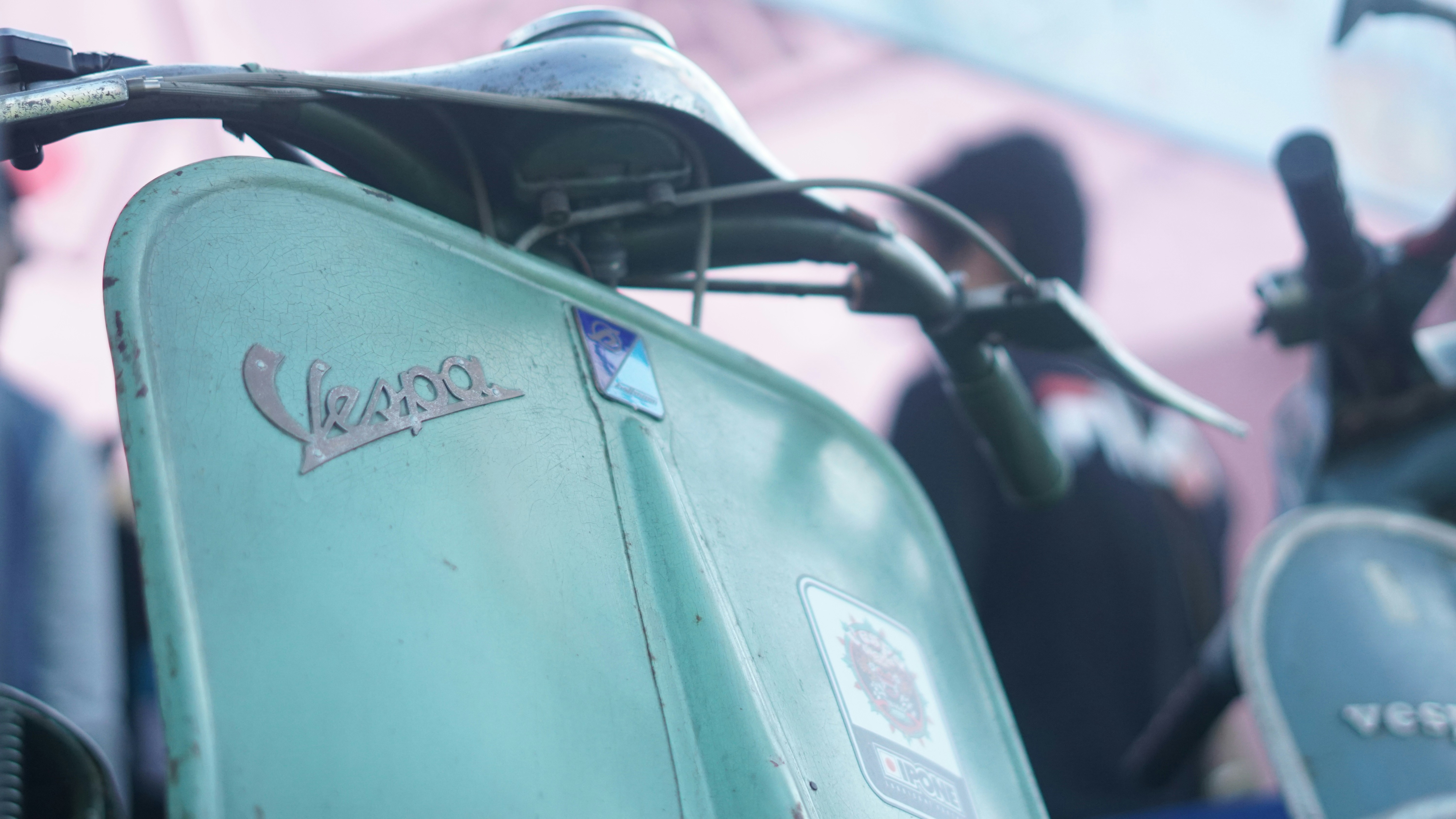 a close up of a green motorcycle parked in a parking lot