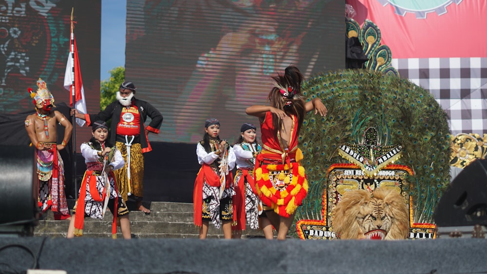 a group of people standing on top of a stage