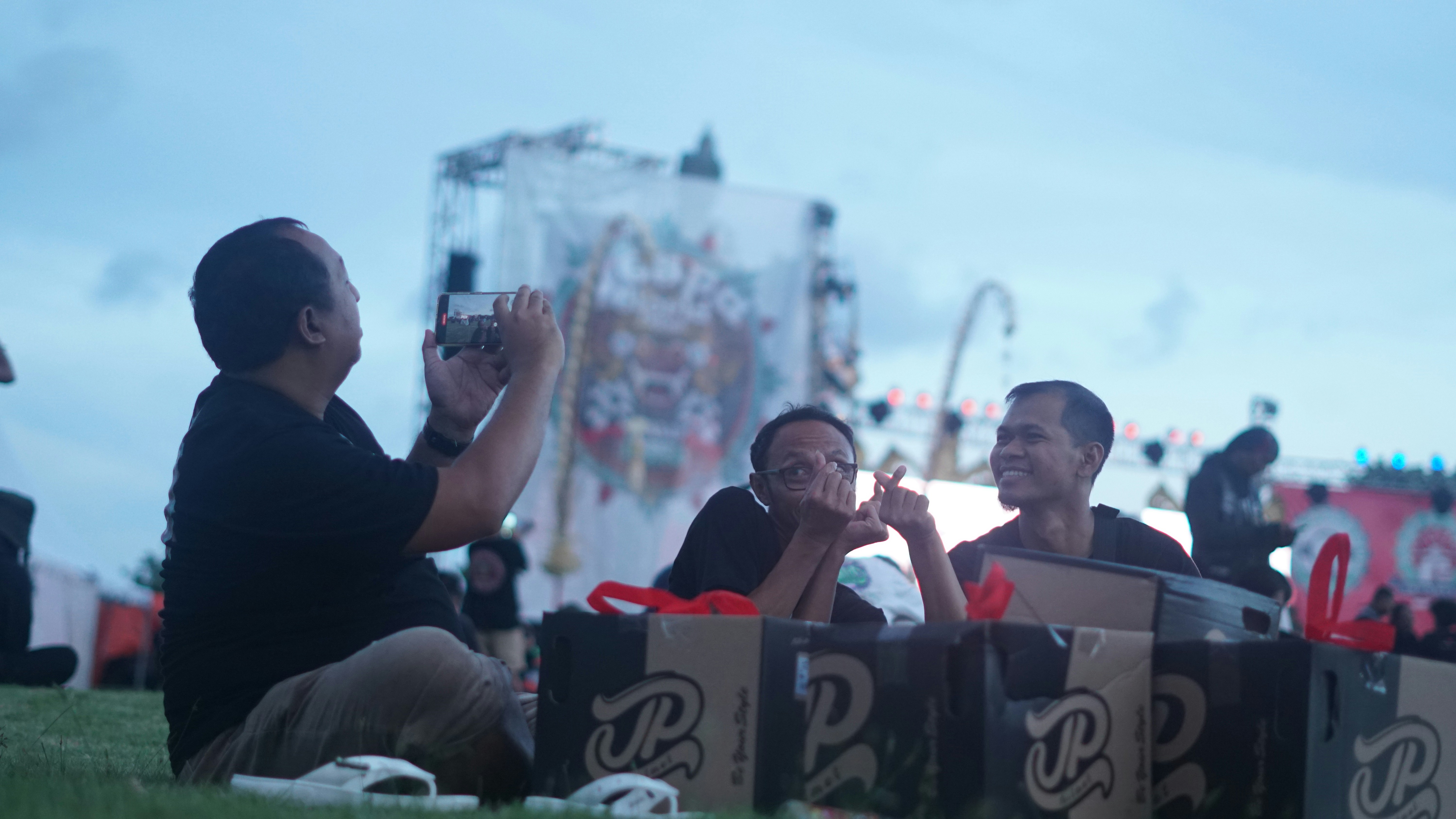 a couple of people that are sitting in the grass