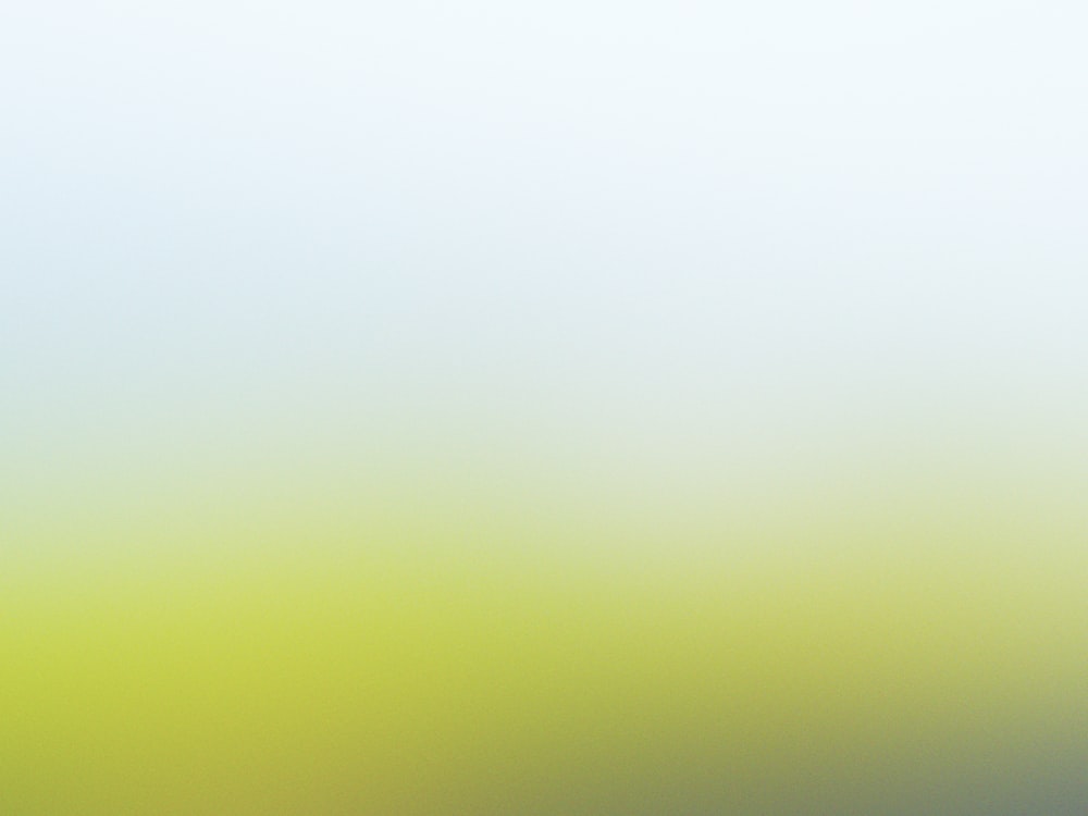 a blurry image of a green and yellow background