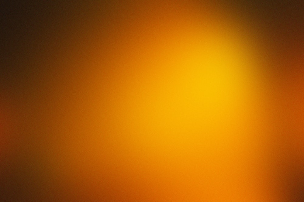 a blurry image of a yellow and orange background