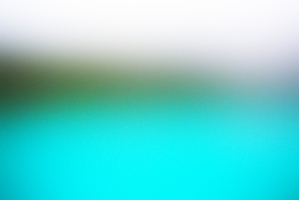 a blurry image of a green and blue background