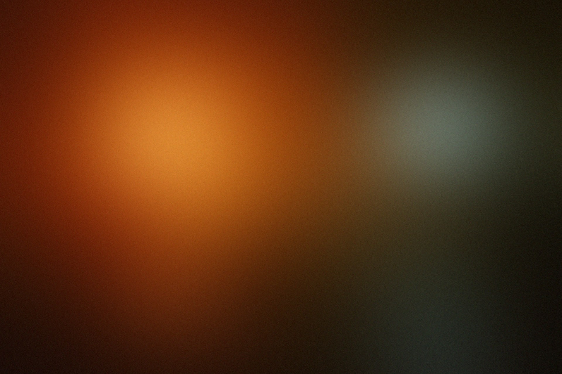 a blurry image of a black and orange background