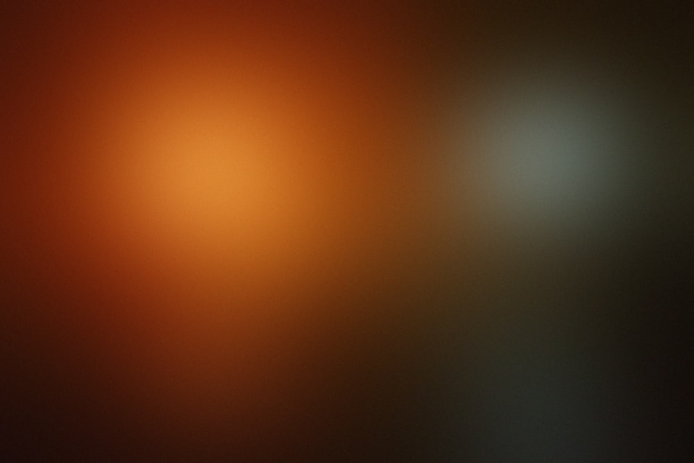 a blurry image of a black and orange background