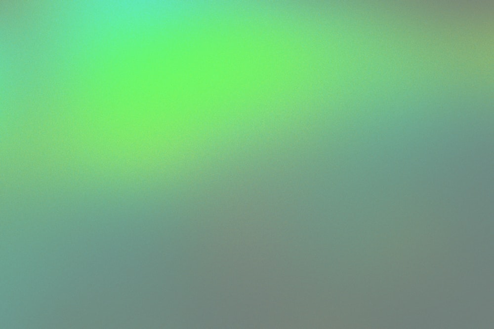 a blurry image of a green and blue background