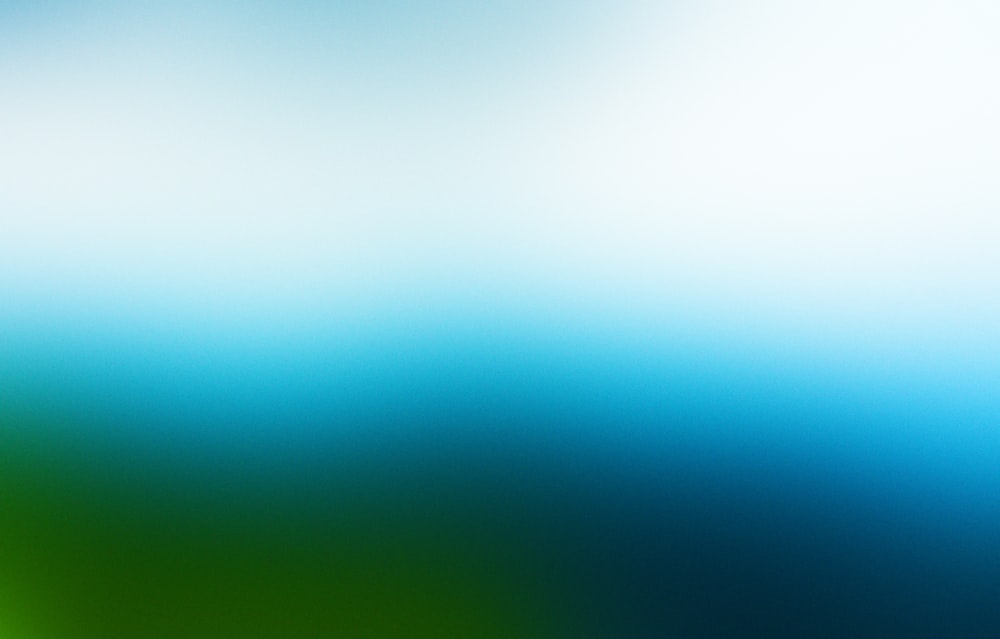 a blurry image of a green and blue background