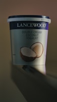 a cup of coconut yogurt sitting on a table