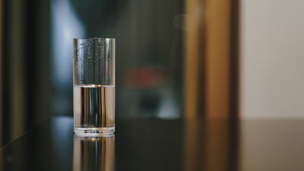 a glass of water sitting on top of a table