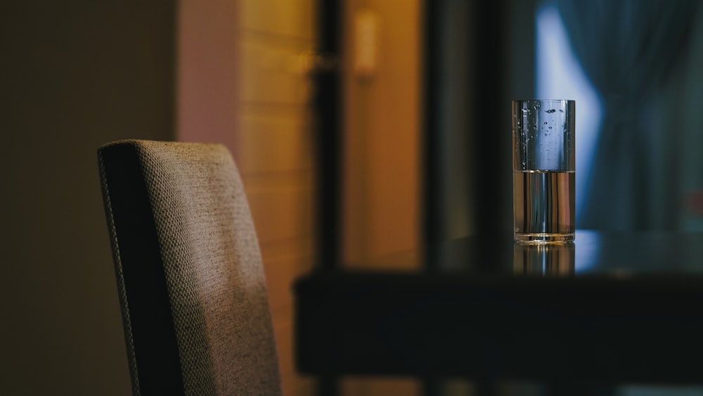 a glass of water sitting on top of a table