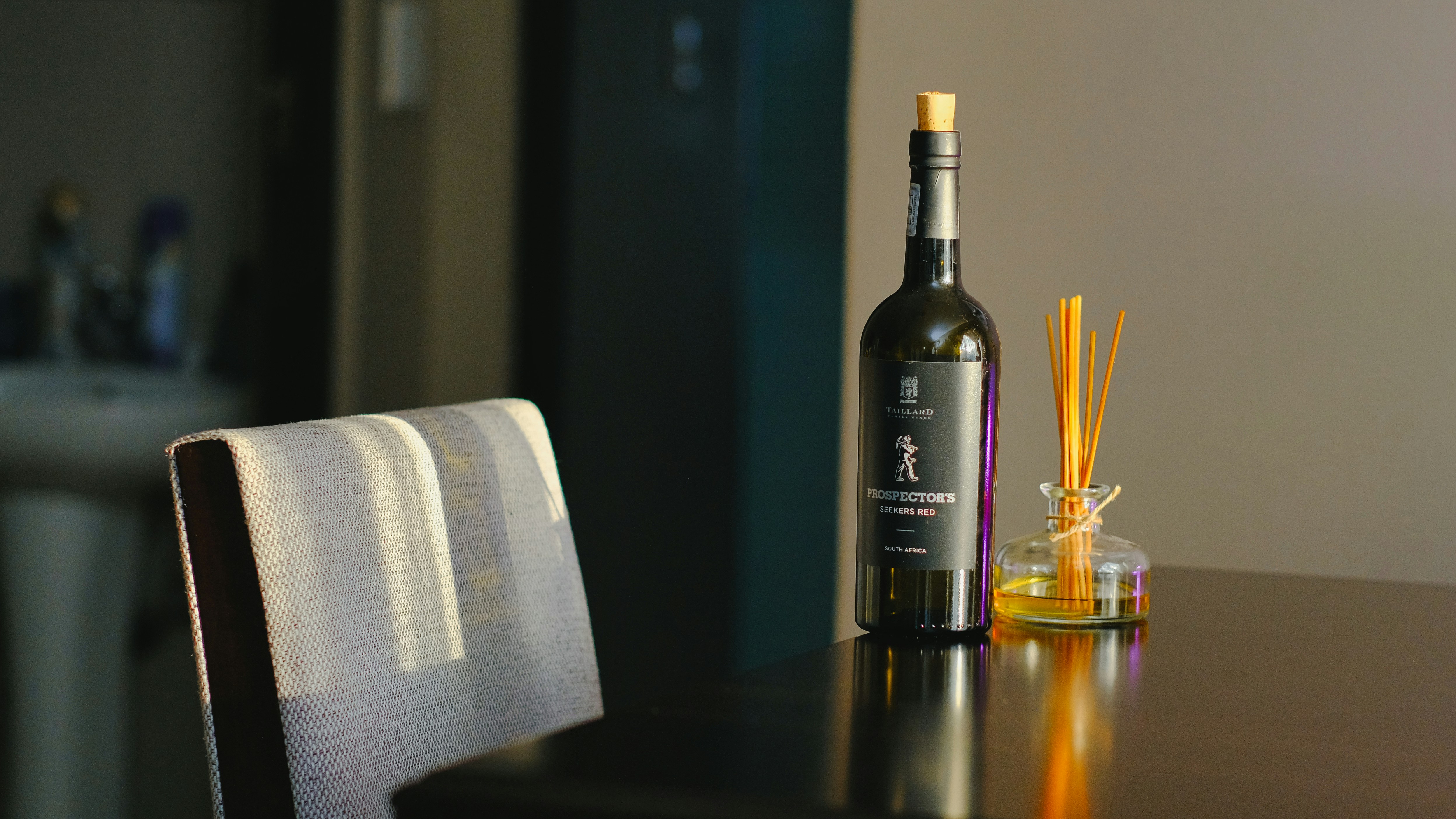 a bottle of wine sitting on top of a wooden table