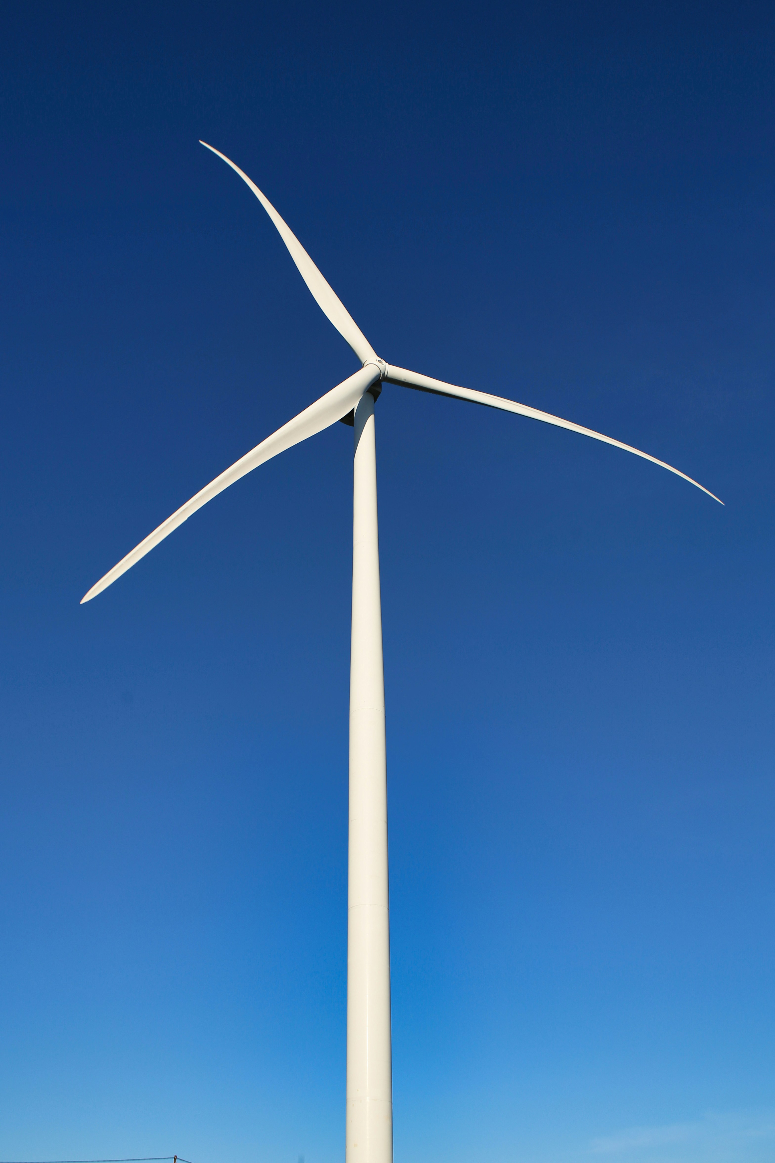 a wind turbine is shown against a blue sky