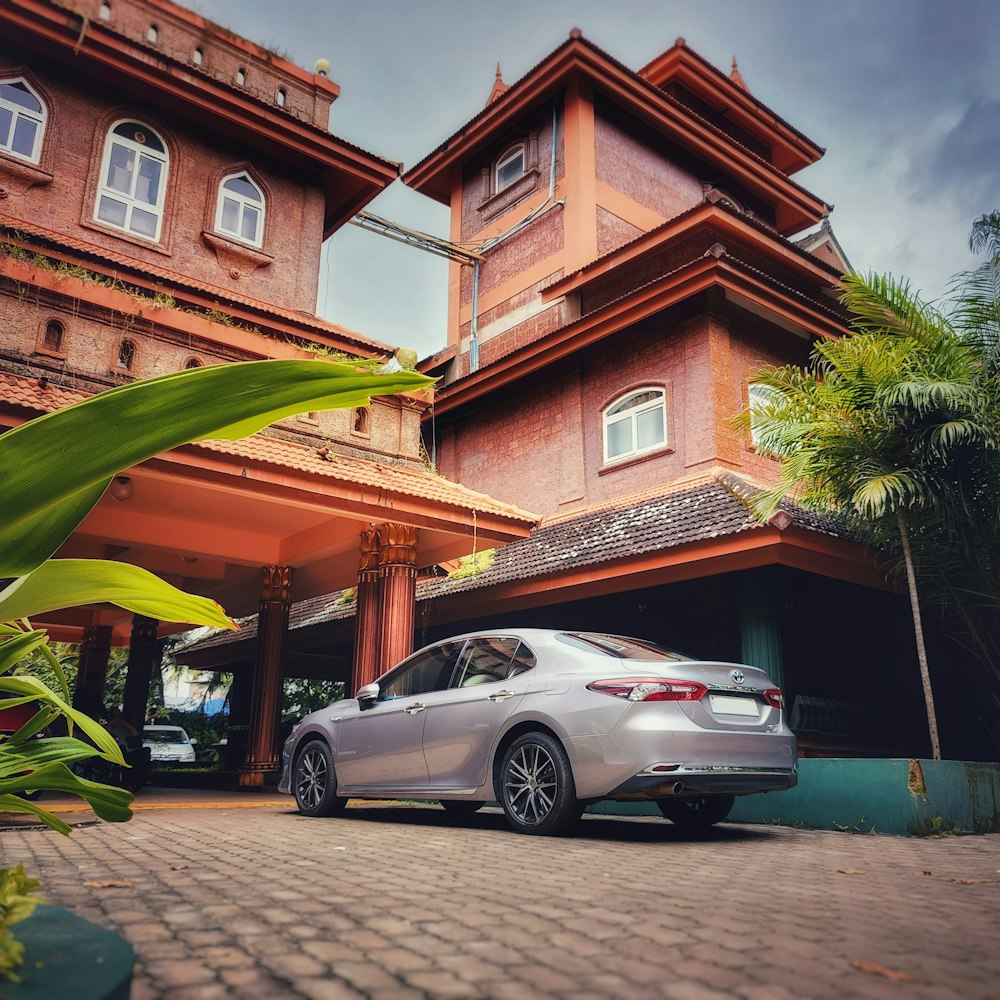 a silver car parked in front of a building