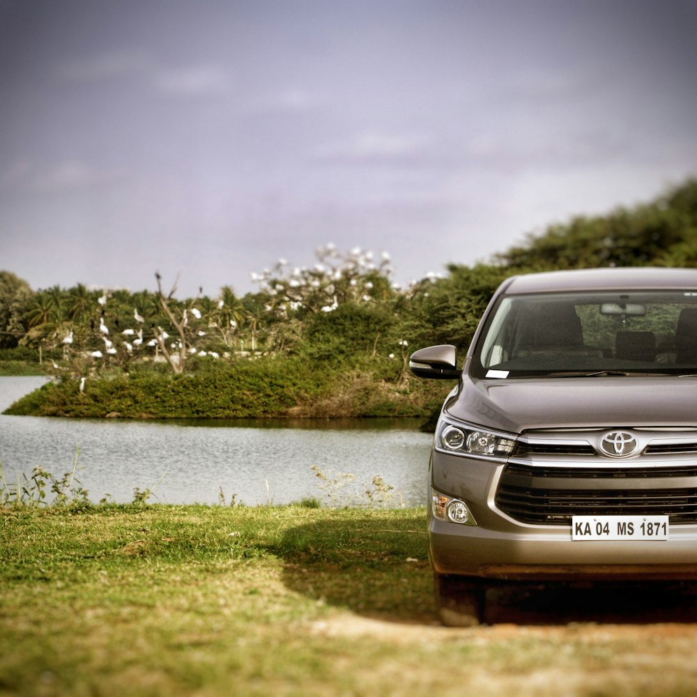 a car parked in front of a body of water