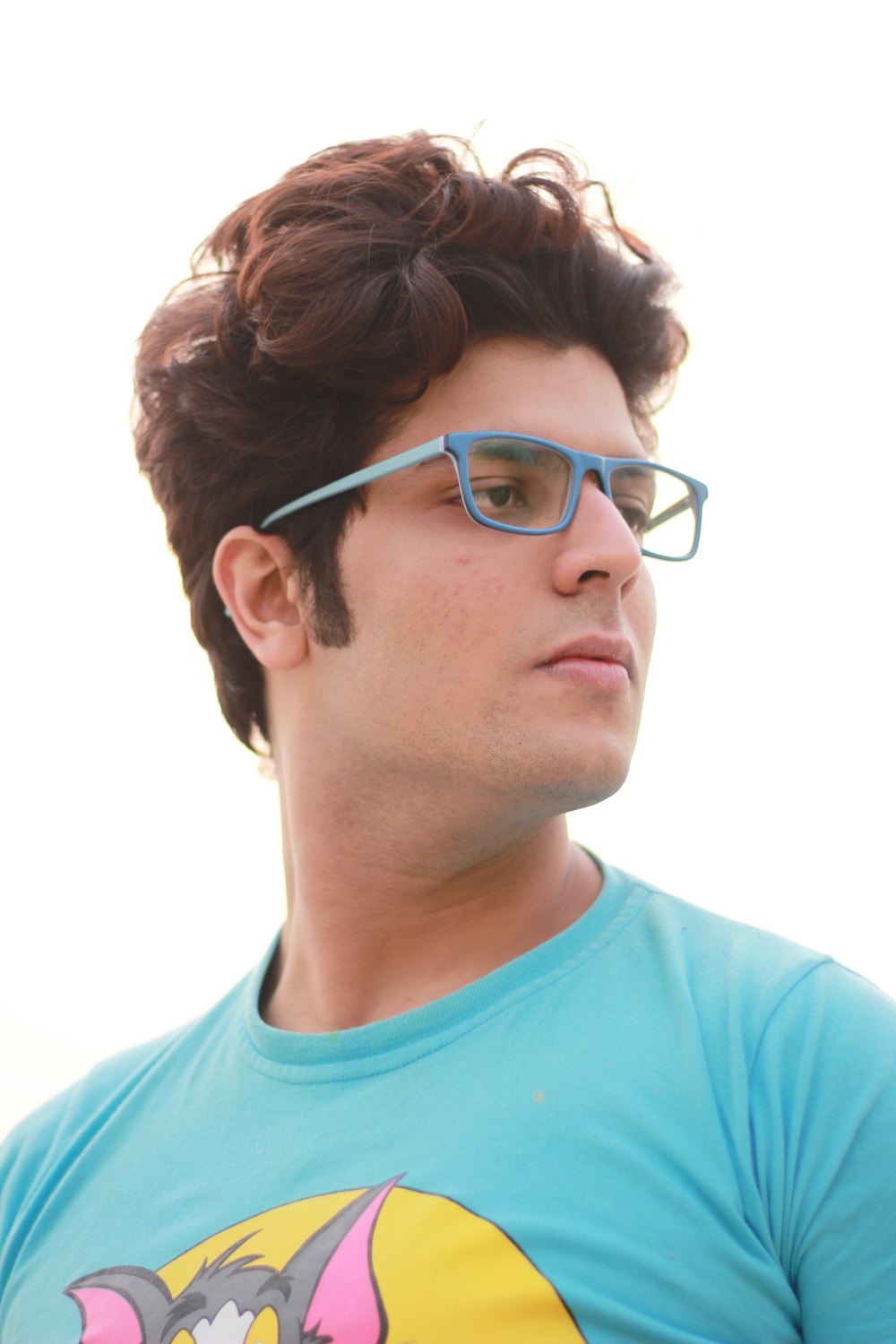 a man wearing glasses and a blue shirt