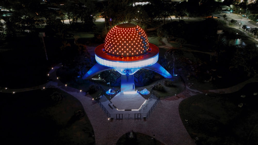 an aerial view of a lit up structure at night