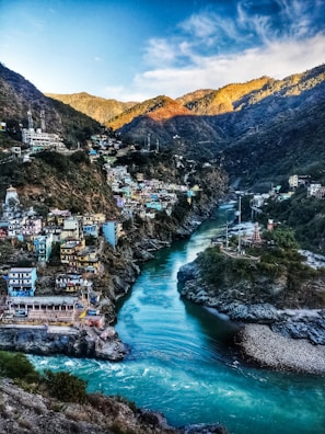 a river running through a lush green hillside