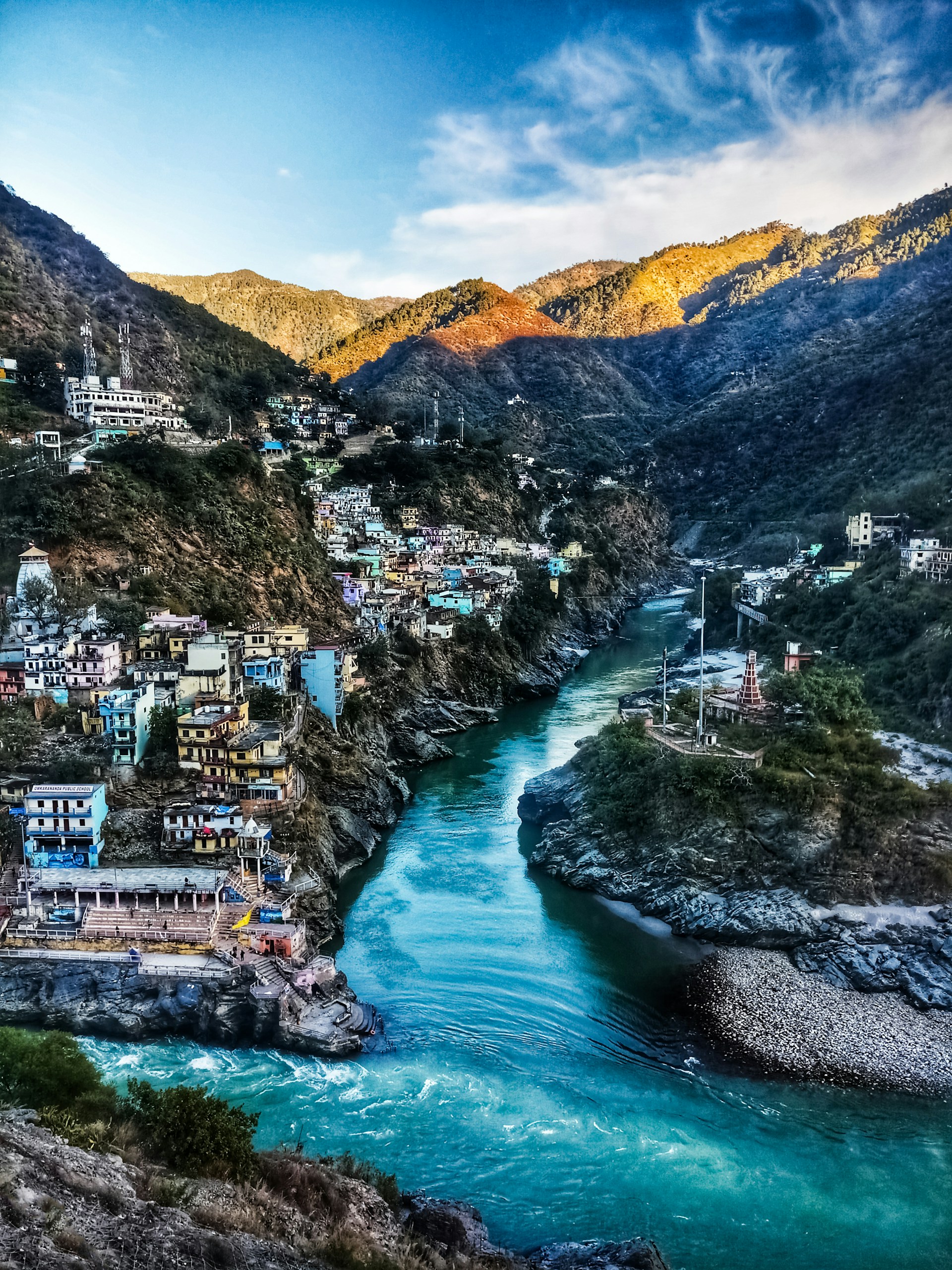 a river running through a lush green hillside