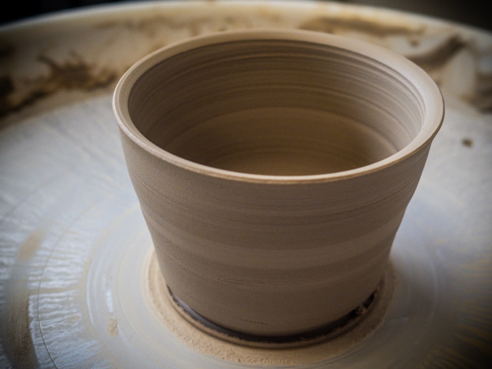 a clay pot sitting on top of a white plate